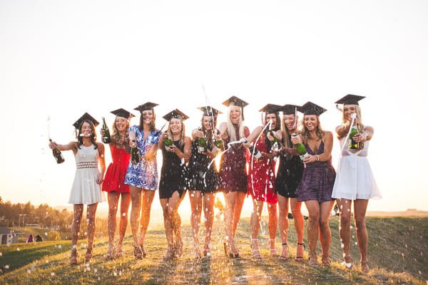 graduation girls popping champagne